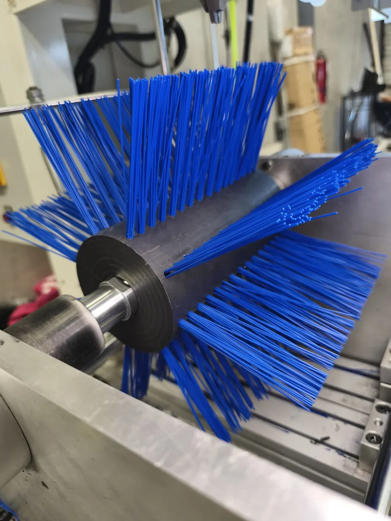 Application-specific blue industrial roller brush in production